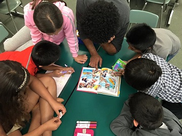 A volunteer reading with kids