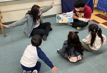 Volunteers reading to Kindergartners at Magnolia