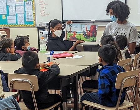 Volunteers reading to Kindergartners at Charles White Elementary