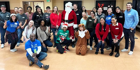 Santa and volunteers at Charles White Elem. reading clubs