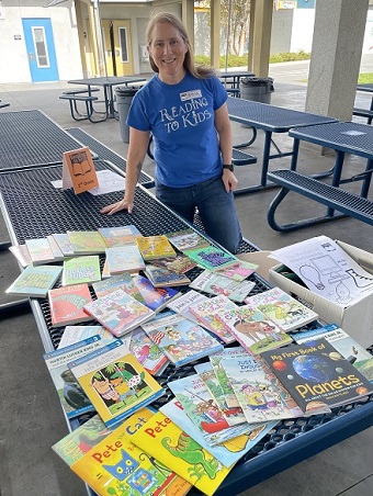 GLC Patricia Briggs at MacArthur Park Elem. with books she brought for the kids to enjoy before the reading clubs start.