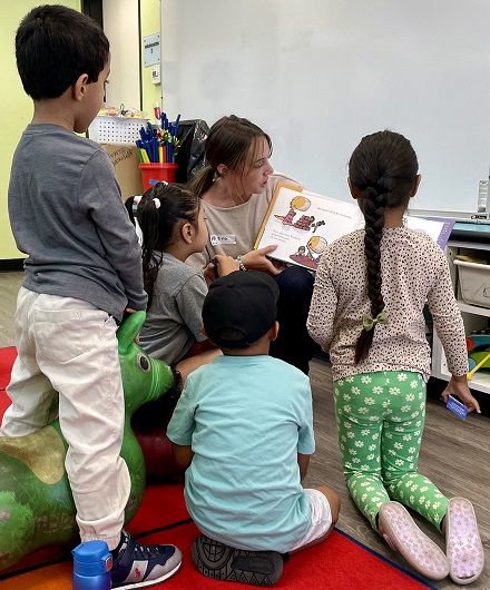 Kindergartens enjoying a book at Politi Elementary