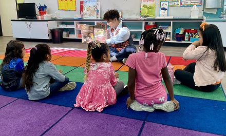 Volunteer reading to Kindergartners at MacArthur Park Elementary