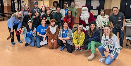 Santa and volunteers at Charles White Elem. reading clubs