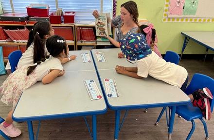 Kindergartners enjoying a book at the reading clubs