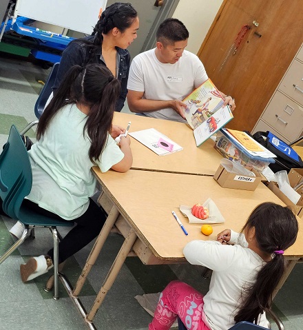 Magnolia Kindergartners enjoying a book at the reading clubs