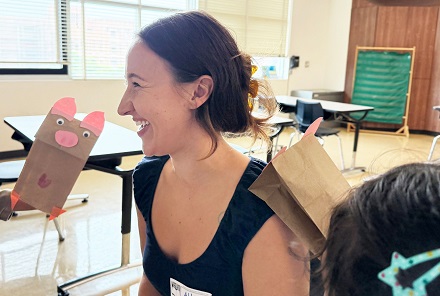 A volunteer enjoying crafts with 1st graders at MacArthur Park Elementary