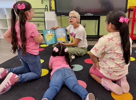 Kindergartners enjoying a book at the reading clubs