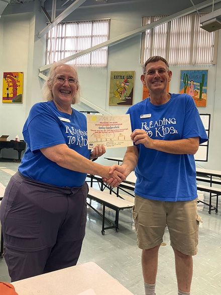 Emily Sandersfeld receiving her 110th reading clubs milestone certificate