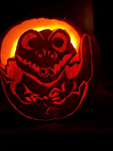 Dinasaur-themed carved pumpkin lit from within at MacArthur Park Elementary