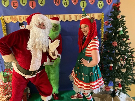 Santa and Joy T. World stop The Grinch at the Magnolia Elementary reading clubs