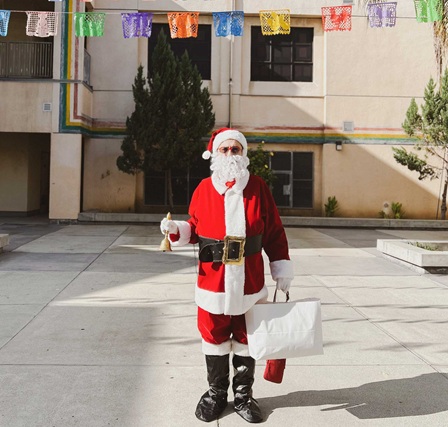 Santa Joniel Barriga with the bells he gave to each child at Politi Elementary