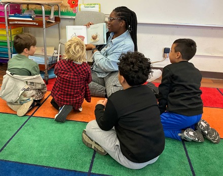 Kids enjoyoying hearing a book at the reading clubs