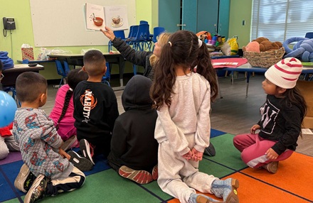 Kindergartners enjoying a book at the reading clubs
