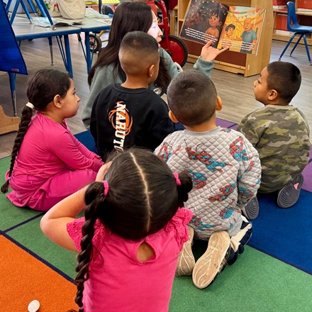 Kids enjoyoying hearing a book at the reading clubs