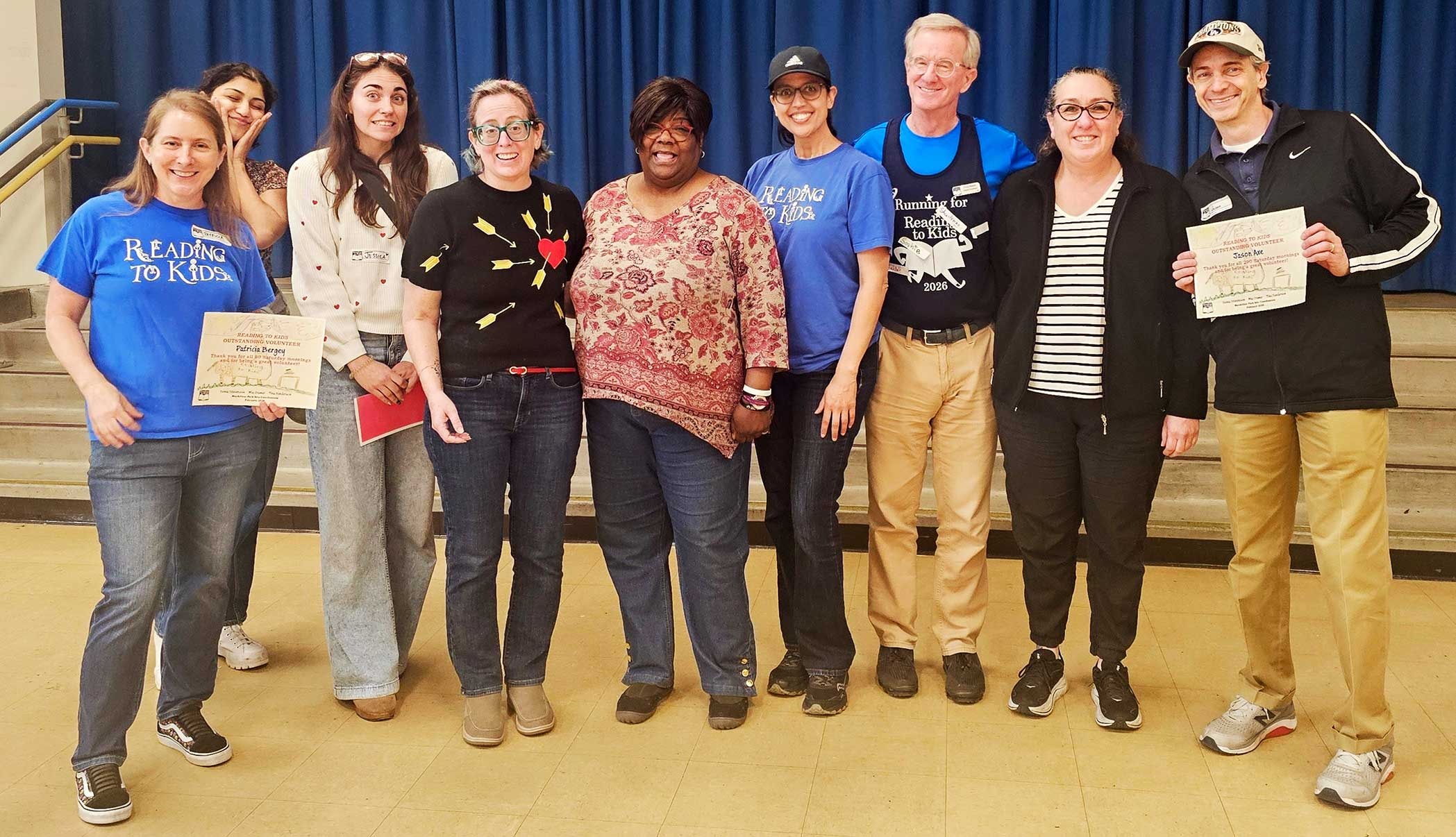 Site Coordinators and volunteers with Patricia Bergey and Jason Axe holding their reading clubs milestone certificates