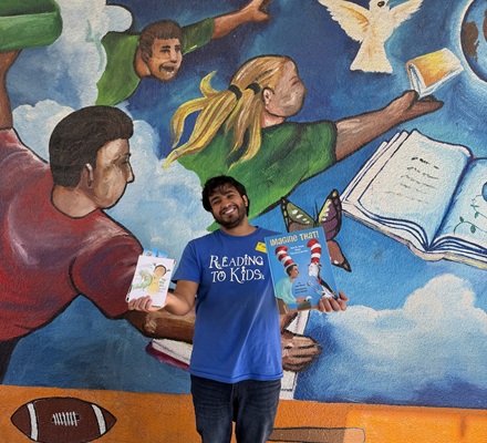 Yancy holding books at the Alta Loma Elementary Career Day