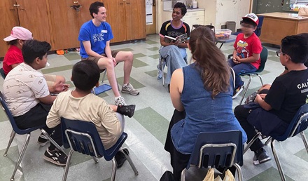 Volunteers and kids enjoying a book at the reading clubs