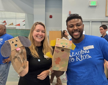 Volunteers with dog crafts at Politi Elementary