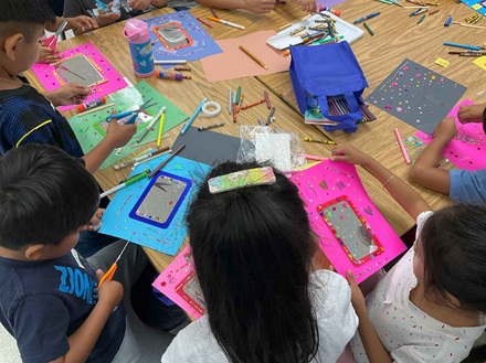 Kids decorating personal mirror crafts at Esperanza Elementary