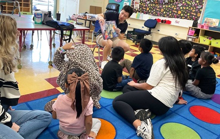Kindergartners enjoying a book at the reading clubs