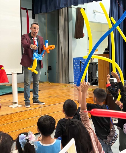 Junior Merlino performing magic at Politi Elementary