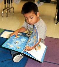 A boy reading at our reading clubs