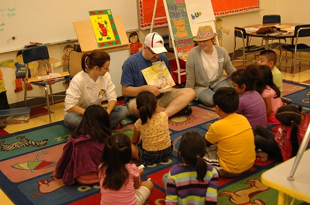 Volunteers reading aloud to kids
