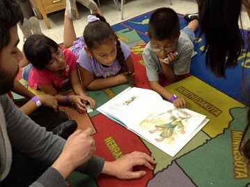 Volunteers and kids at Politi Elementary reading clubs