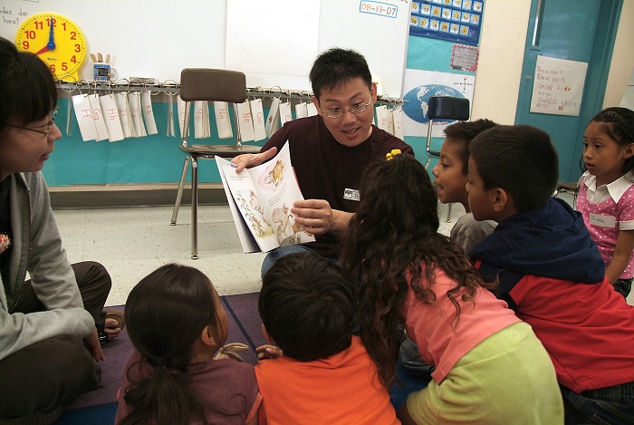 Volunteers reading aloud to kids