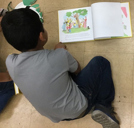 A Politi 3rd grader enjoys a book he received from Reading to Kids